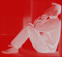 Image of man sitting on floor crying